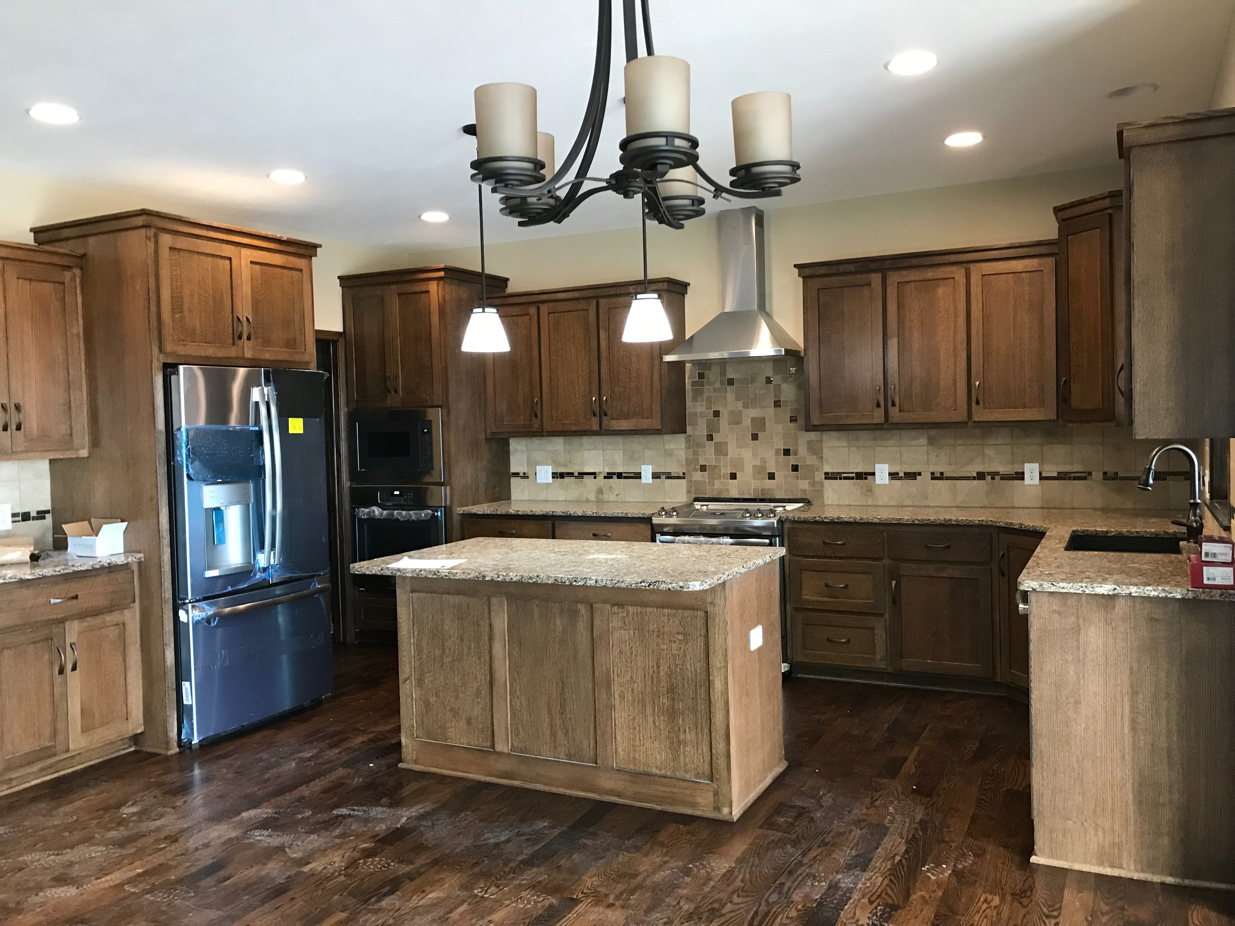 Two-tone wood stained cabinets with island